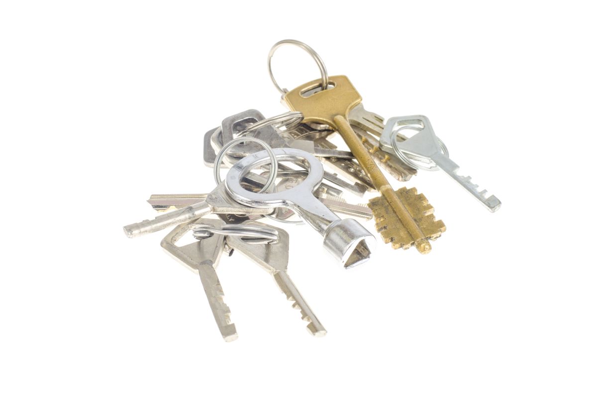 Bundles of old keys on white background.